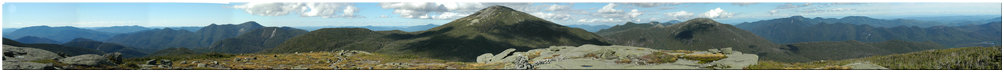 Looking northeast at Santanoni Peak, Panther Peak, Henderson Mtn, Mt. Adams, Calamity Mtn, Cliff Mtn, Mt. Emmons, Mt. Donaldson, Seward Mtn, Seymour Mtn, MacNaughton Mtn, Mt. Marshall, Iroquois Mtn, Algonquin Peak, Wright Peak, Mt. Colden, Gray Peak, Whiteface Mtn, Mt. Marcy, Hurricane Mtn, Basin Mtn, Gothics Mtn, Pyramid Peak, Little Haystack, Mt. Haystack, Giant Mtn, Dial Mtn, Nippletop Mtn, Mt. Dix, Mt. Colvin, Blake Mtn, Hough Peak, South Dix Mtn, Macomb Mtn